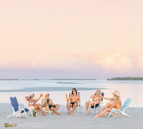 Semi-circle of people in Sunflow chairs on beach
