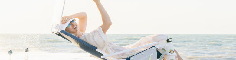 Person in sunglasses leaning back in beach chair